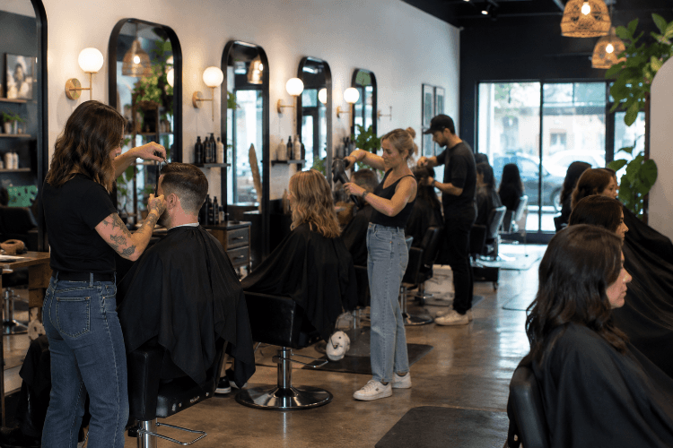 Busy salon floor with artists working
